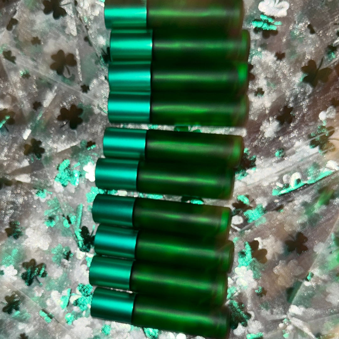 Green roll on bottles on a decorative paper with clover patterns