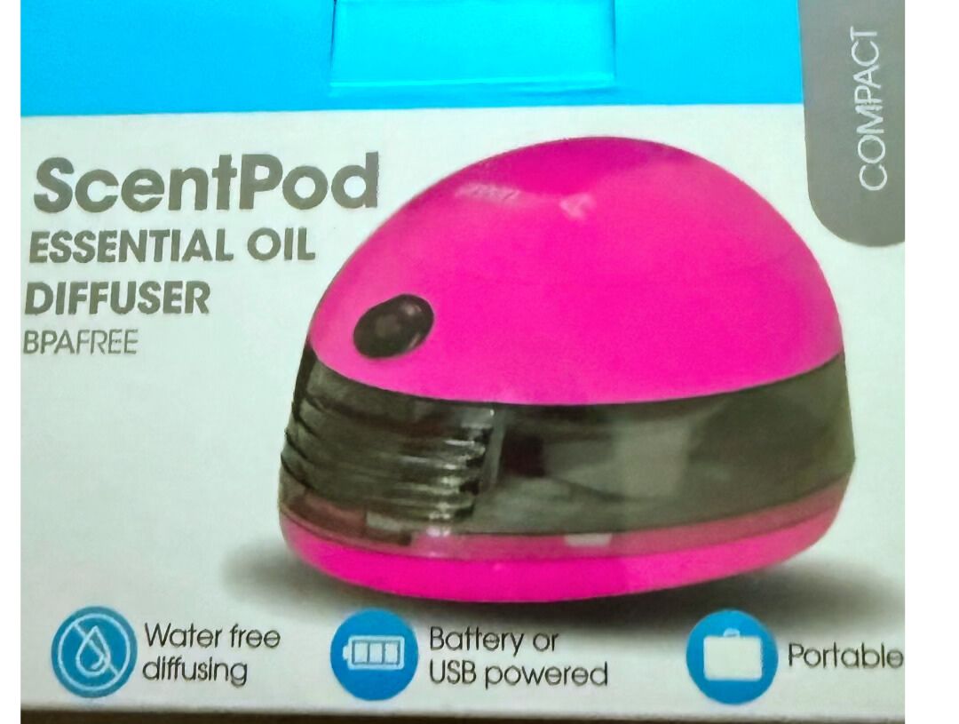 Pink essential oil diffuser on a white background with blue accents